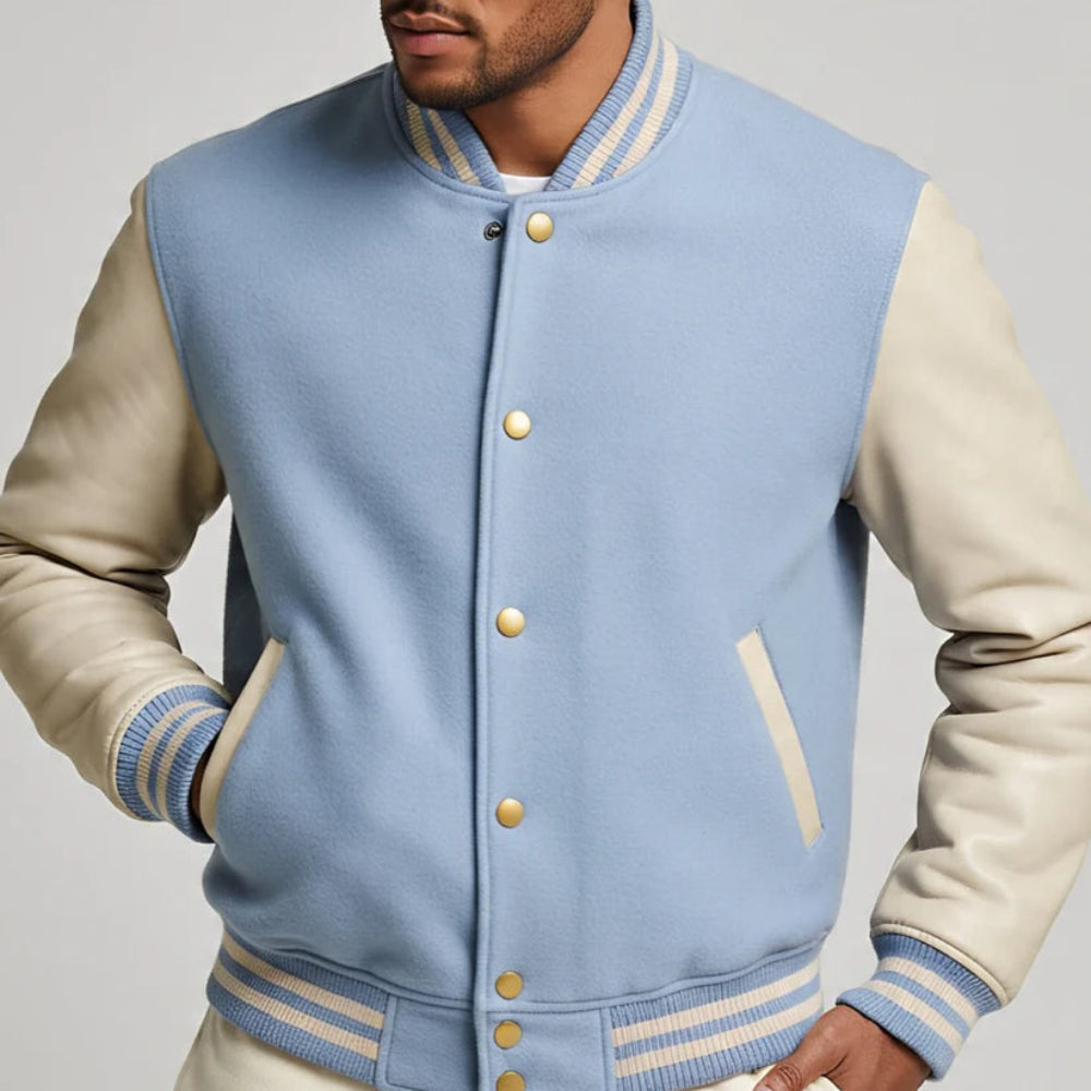 Light blue and beige varsity jacket with gold buttons on a plain background