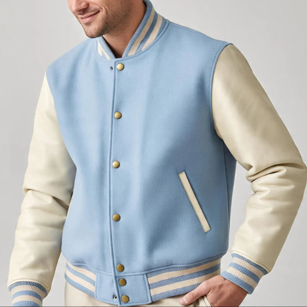 Light blue and beige varsity jacket worn by a person on a gray background