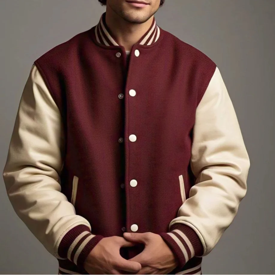 A person wearing a maroon and cream varsity letterman jacket with leather sleeves and a traditional button closure.